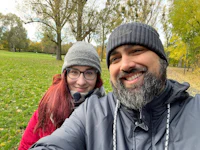 a man and woman taking a selfie in a park